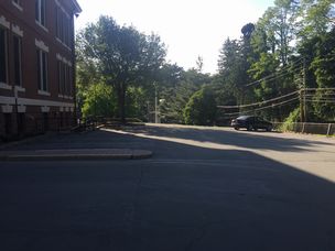 Photo of entrance to Municiapl Bldg parking lot - Mucniciapl building is on the right.