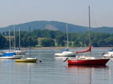 View of calm wiater with several sailboats moored